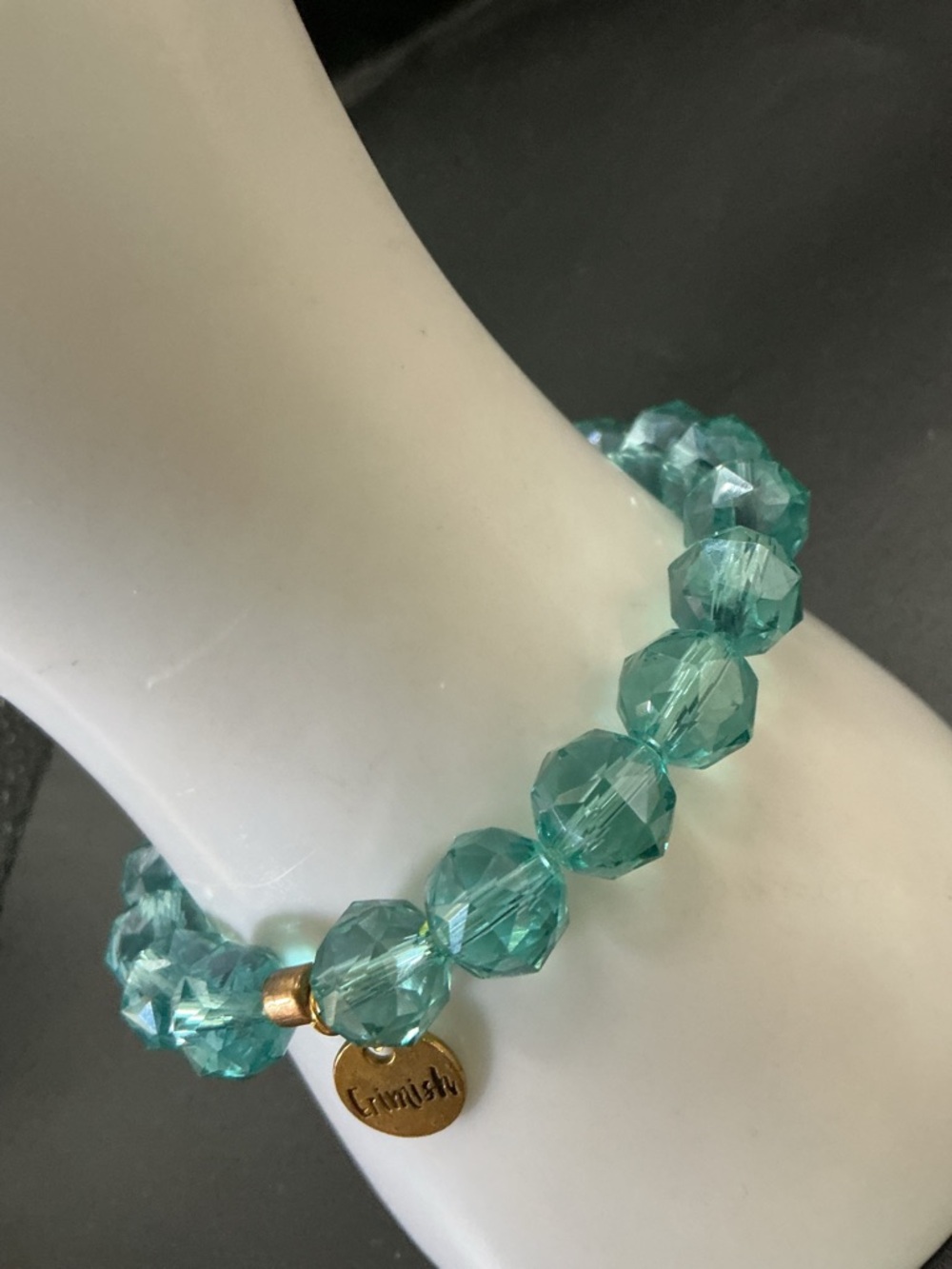 ERMISH TEAL TRANSPARENT FACETED GLASS BEAD AND SILVER TONE DISC STRETCH BRACELET